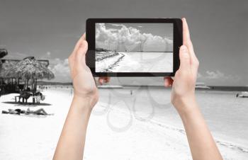 travel concept - tourist taking photo of Atlantic Ocean coastline in Varadero on mobile gadget, Cuba