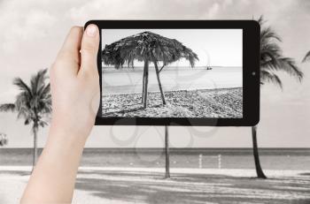travel concept - tourist taking photo of sand beach in Varadero on mobile gadget, Cuba