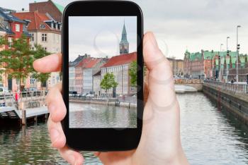travel concept - tourist taking photo of Copenhagen cityscape on mobile gadget, Denmark