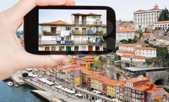 travel concept - tourist taking photo of Porto city on mobile gadget, Portugal