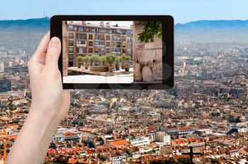 travel concept - tourist takes picture of square at rue du lacydon in Marseilles city, France on smartphone,