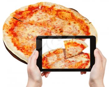 photographing food concept - tourist takes picture of italian pizza Margherita on smartphone, Italy