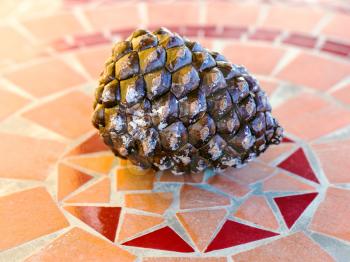 italian pine cone on mosaic stone table