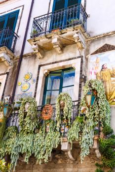 TAORMINA, ITALY - APRIL 3, 2015: balcony with typical decoration of house in Taormina town, Sicily.