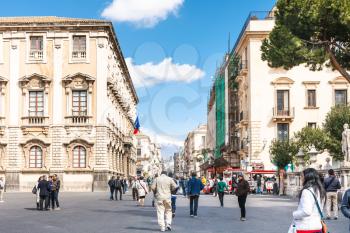 CATANIA, ITALY - APRIL 5, 2015: tourists at via Etnea and view Etna volcano in Catania, Sicily, Italy. Etnea is the main street of historical center of Catania, it is about three kilometers long.