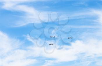 turboprop bomber aircrafts in white clouds in blue sky