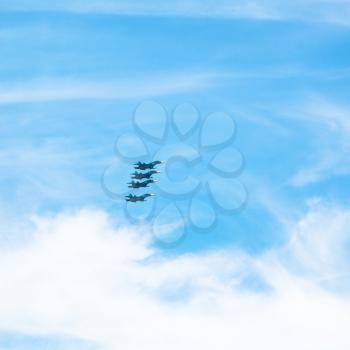 four green military fighter aircrafts in cloudy blue sky