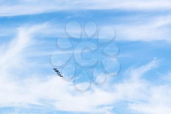 blue sky with white clouds and military fighter planes
