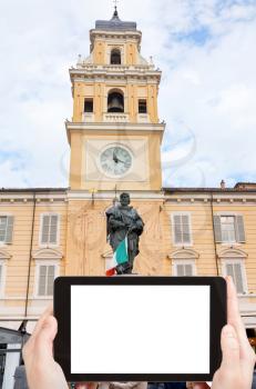 travel concept - tourist photograph Giuseppe Garibaldi Monument with clock bell tower of Palazzo del Governatore in Parma, Italy on tablet pc with cut out screen with blank place for advertising logo