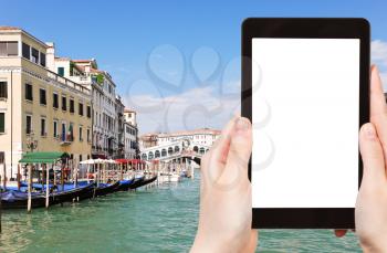 travel concept - tourist photograph Grand Canal near Rialto Bridge (Ponte di Rialto) in Venice, Italy on tablet pc with cut out screen with blank place for advertising logo