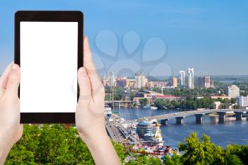 travel concept - tourist photograph Kiev cityscape and Dnieper river, Ukraine on tablet pc with cut out screen with blank place for advertising logo
