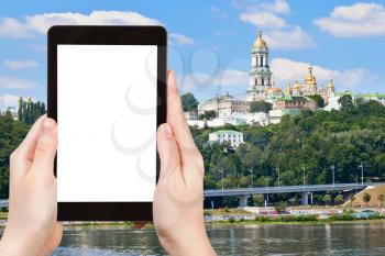 travel concept - tourist photograph riverside view of Kiev Pechersk Lavra, Kiev, Ukraine on tablet pc with cut out screen with blank place for advertising logo