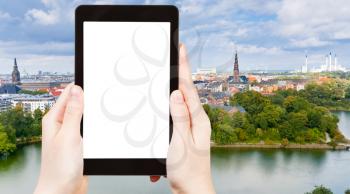 travel concept - tourist photograph Copenhagen city skyline, Denmark on tablet pc with cut out screen with blank place for advertising logo