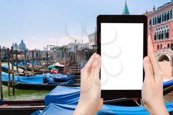 travel concept - tourist photograph gondolas near Piazza San Marco in Venice, Italy on tablet pc with cut out screen with blank place for advertising logo