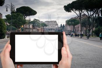 travel concept - tourist photograph via dei Fori Imperiali road to Coliseum in Rome, Italy on tablet pc with cut out screen with blank place for advertising logo