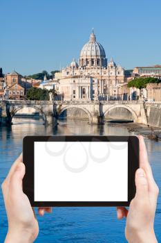 travel concept - tourist photograph view of Angel Bridge on Tiber river and St Peter Basilica in Rome, Italy on tablet pc with cut out screen with blank place for advertising logo