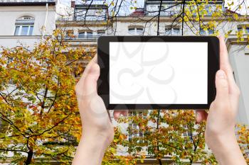 travel concept - tourist photograph facade of urban mansion of the 19th century on Fasanenstrasse in Berlin in autumn on tablet pc with cut out screen with blank place for advertising logo