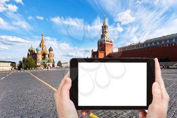 travel concept - tourist photograph Red Square with Saint Basil Cathedral and Spasskaya Tower in Moscow, Russia on tablet pc with cut out screen with blank place for advertising logo