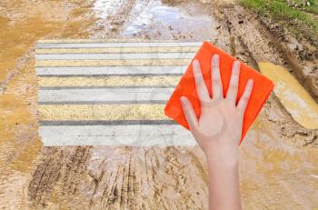 weather concept - hand deletes mug on country road by orange cloth from image and urban road is appearing