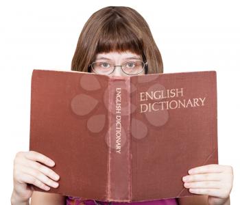 direct view of girl with glasses looks over English Dictionary book isolated on white background