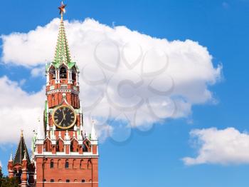 Spasskaya clock Tower of Moscow Kremlin and white cloud in blue sky in sunny day