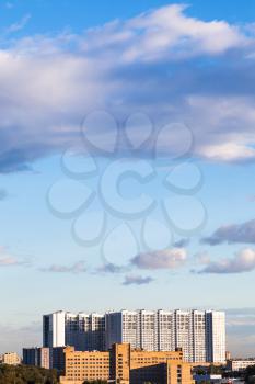 modern apartment buildings under blue sky with evening clouds in summer