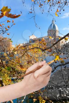 travel concept - hand with paintbrush paints yellow leaves on waterfront in Rome, Italy