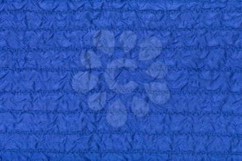textile background from stitched wrinkled blue silk fabric