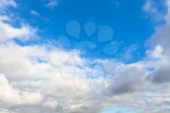 natural background - low gray and white autumn clouds in blue sky