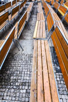 empty wooden benches on urban square in autumn in Brno city