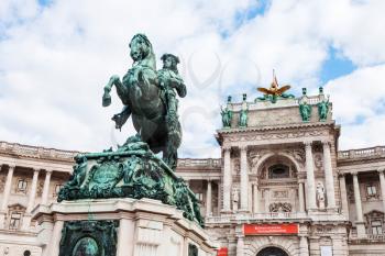 travel to Vienna city - statue of Prince Eugene of Savoy on Heldenplatz and facade of Neue Burg in Hofburg Palace, Vienna, Austria