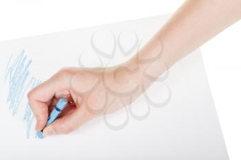 hand paints by blue crayon on sheet of paper isolated on white background