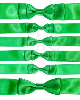 set of real bow knots on green satin ribbons isolated on white background