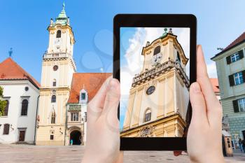 travel concept - tourist snapshot of Old Town Hall at Main Square in Bratislava on tablet pc