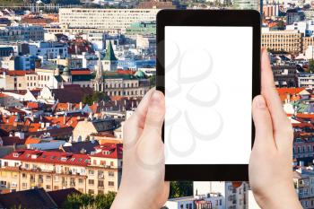 travel concept - tourist photographs Bratislava city skyline on tablet pc with cut out screen with blank place for advertising logo