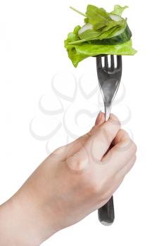 fresh green salad impaled on fork in female hand isolated on white background