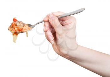 hand holds spoon with cabbage soup in meat broth isolated on white background