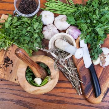 cooking seasonings - top view of mortars and spicy ingredients on wooden table