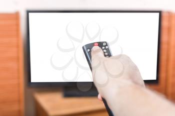 Hand turns off TV with cut out screen by remote control in living room