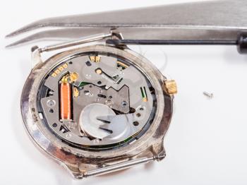 Repairing of watch - tools and replacing battery in quartz watch close up