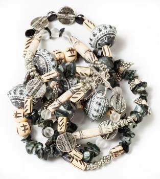 tangled necklace from coquina, beads, acrylic, rhinestone, bone, metal beads on white background
