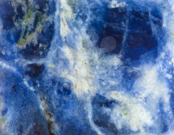 blue and whte background from surface of Sodalite natural mineral gem stone