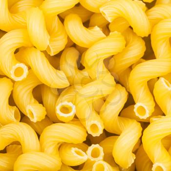 square food background - durum wheat semolina pasta cavatappi close up