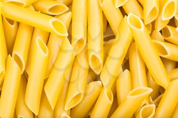food background - durum wheat semolina pasta penne lisce