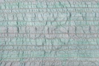 textile background - handmade stitched green fabric
