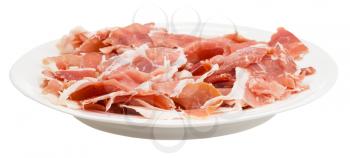 side view of thin sliced dry-cured ham on white plate isolated on white background