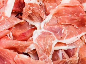 food background - thin slices of dry-cured ham close up