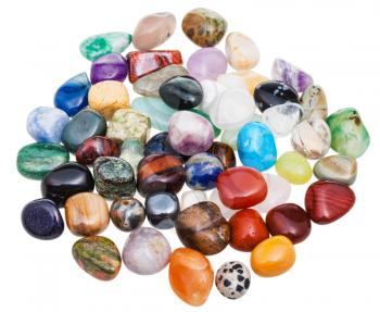 above view of handful of various gem stones on white background