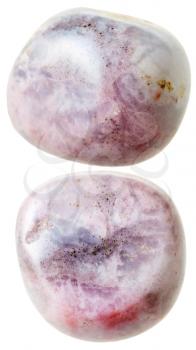 natural mineral gem stone - two Rhodonite gemstones isolated on white background close up