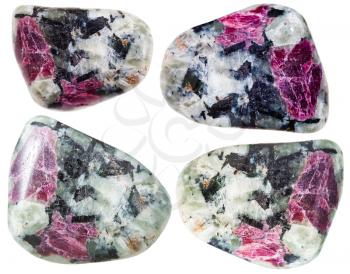 natural mineral gem stones - tumbled corundum crystals in rocks isolated on white background